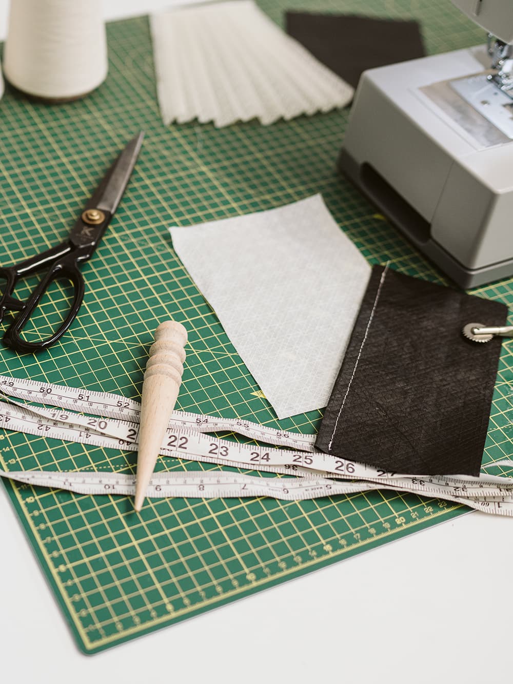 Samples of non-woven biomaterial laying on an atelier cutting table ready to be designed