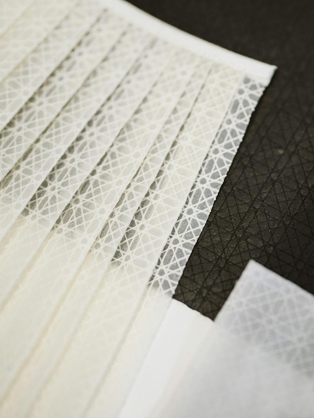 Black and white non-woven materials that have been made with bacteria and natural textile scaffolding